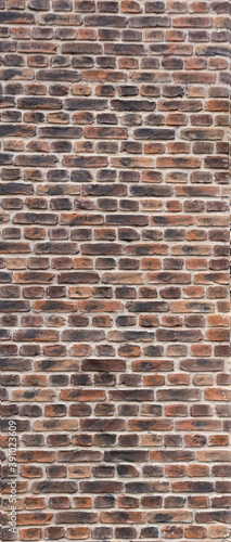  An old brick wall made of bricks of an unusual color.