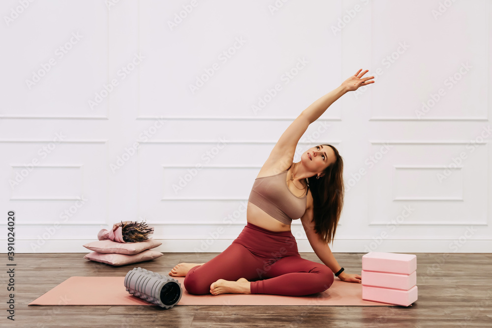 Fototapeta premium Sporty young woman doing yoga practice on white background. concept of healthy life and natural balance between body and mental development