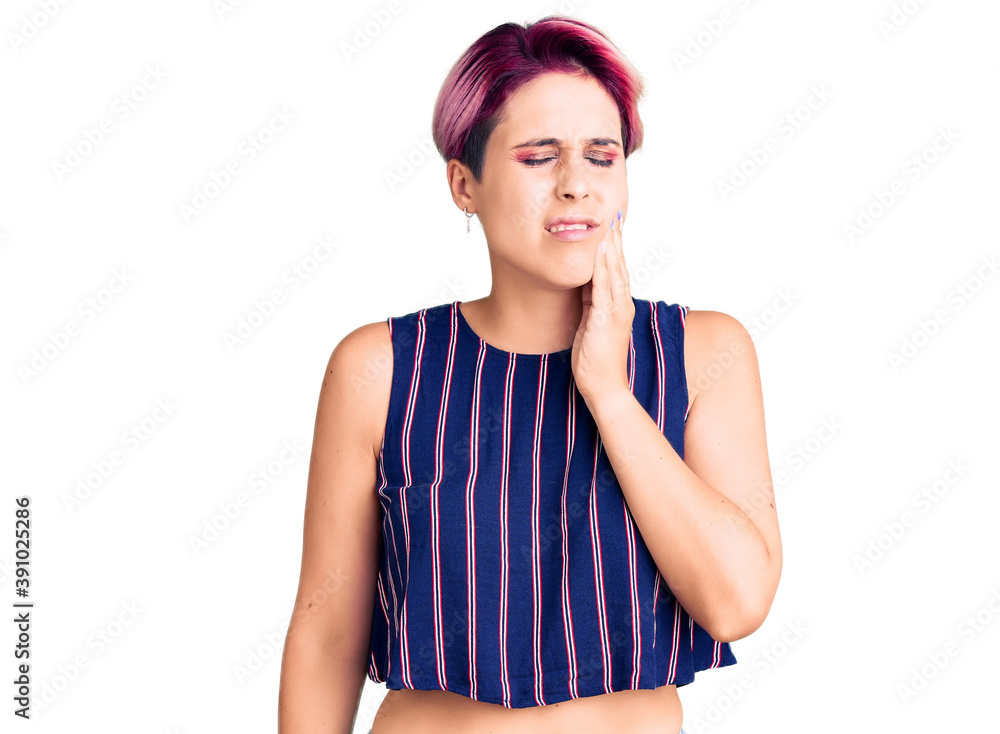 Young beautiful woman with pink hair wearing casual clothes touching mouth with hand with painful expression because of toothache or dental illness on teeth. dentist Young beautiful woman with pink hair wearing casual clothes touching mouth with hand with painful expression because of toothache or dental illness on teeth. dentist