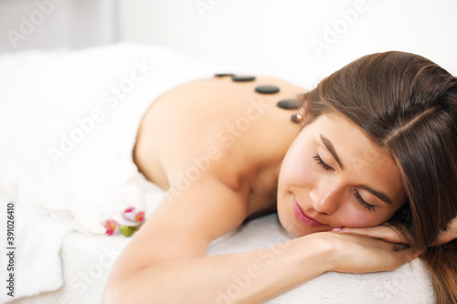 Young beautiful woman receiving spa treatment in spa beauty salon. Wellness massage. Beauty salon.