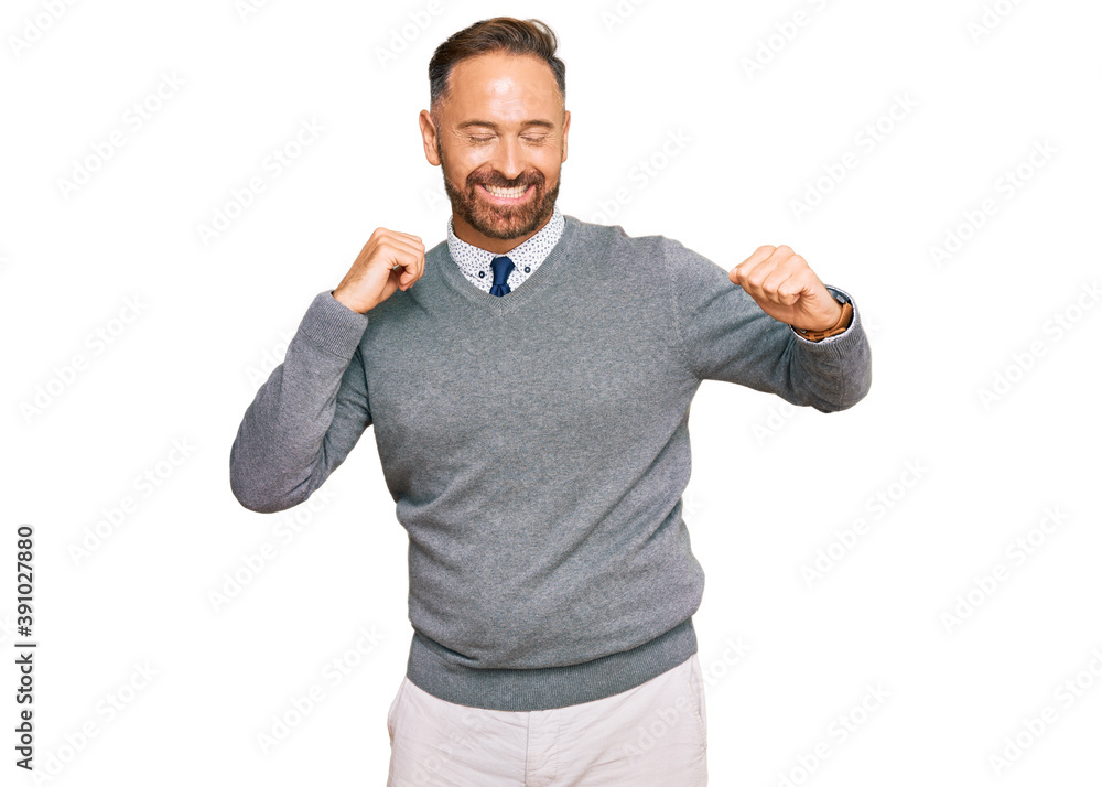Fototapeta premium Handsome middle age man wearing business clothes dancing happy and cheerful, smiling moving casual and confident listening to music