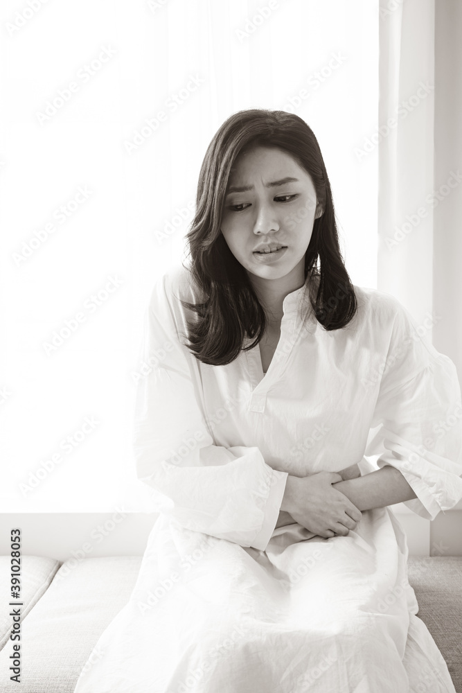 asian woman with menstruation and pain period cramps. asian woman with menstruation and pain period cramps.