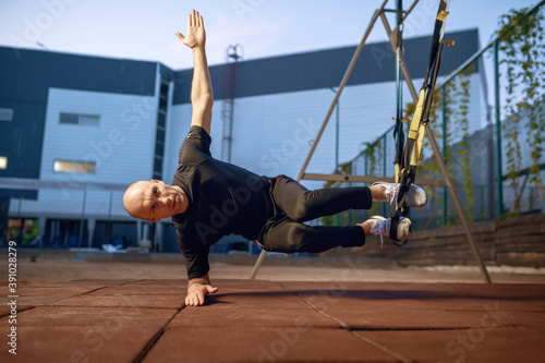Fototapeta Naklejka Na Ścianę i Meble -  Sportive man doing balance exercise outdoors