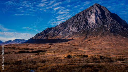 Fototapeta Naklejka Na Ścianę i Meble -  Detailed mountain set against a bright blue sky on an autumn day at Buachaille Etive Mor Glen Coe Scotland