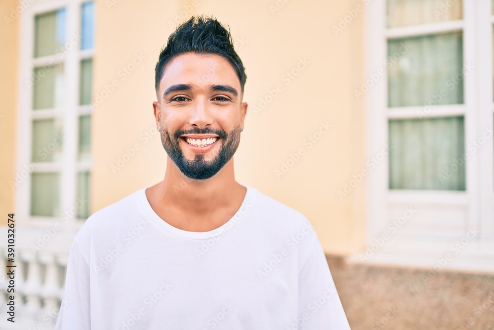 Young arab man smiling happy walking at the city. Young arab man smiling happy walking at the city.