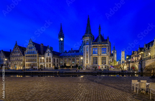 View of Graslei, Korenlei quays, Leie river and St Michael's bridge in the historic city center in Ghent (Gent), Belgium. Architecture and landmark of Ghent. Night cityscape of Ghent.