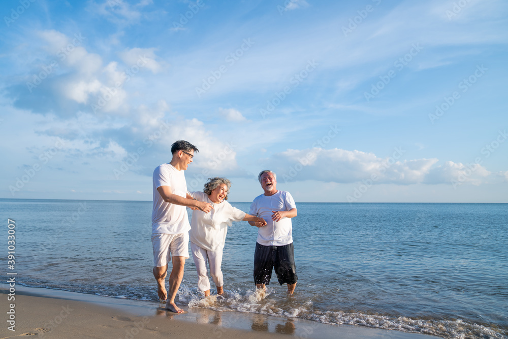 Family On Summer Beach Vacation, Father and mather running with son, Concept for .caring for the elderly, Caregiving to older persons and relations of the family to support elderly state Family On Summer Beach Vacation, Father and mather running with son, Concept for .caring for the elderly, Caregiving to older persons and relations of the family to support elderly state
