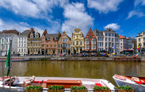 View of Korenlei quay and Leie river in the historic city center in Ghent (Gent), Belgium. Architecture and landmark of Ghent. Sunny cityscape of Ghent. photo