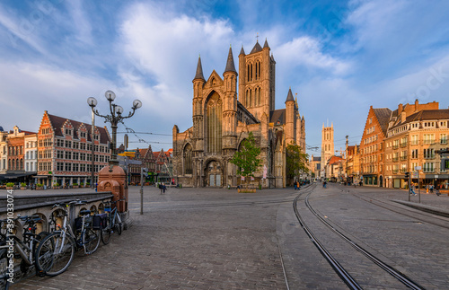 Medieval city of Gent (Ghent) in Flanders with Saint Nicholas Church and Korenmarkt square, Belgium. Sunny cityscape of Ghent. Sunset cityscape of Ghent.