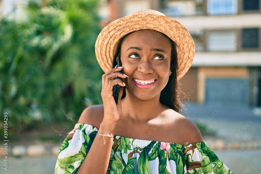 Young african american tourist woman on vacation smiling happy talking ...