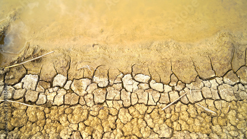 Global warming issue Cracked earth and Dry water is soft focus, Full Frame Shot of Cracked Land, Soil Texture, Faded, Weak Reds