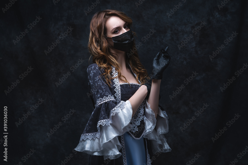 Beautiful woman in renaissance dress, face mask and gloves on abstract dark background