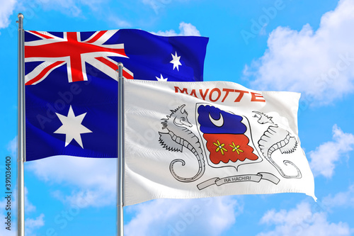 Mayotte and Australia national flag waving in the windy deep blue sky. Diplomacy and international relations concept.