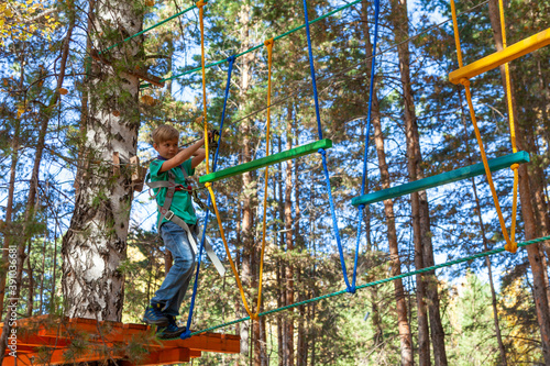 A young tourist trains on a hanging rope structure.