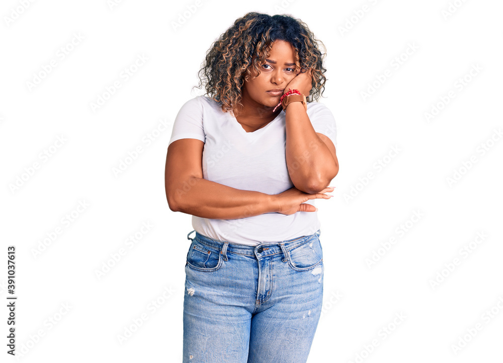 Young african american plus size woman wearing casual clothes thinking looking tired and bored with depression problems with crossed arms. Young african american plus size woman wearing casual clothes thinking looking tired and bored with depression problems with crossed arms.
