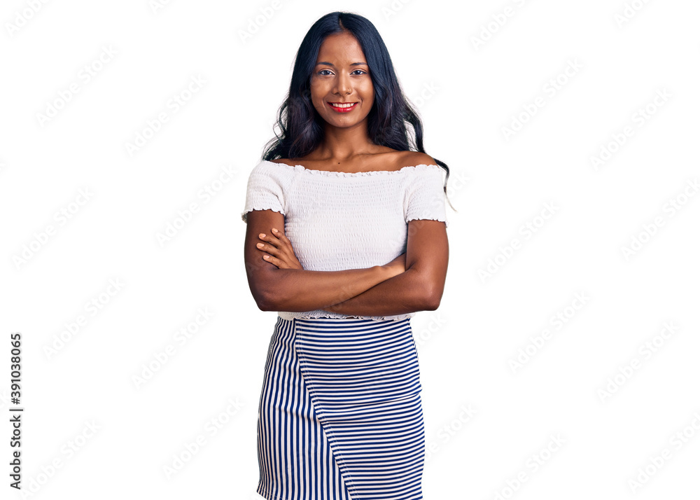 Young indian girl wearing casual clothes happy face smiling with crossed arms looking at the camera. positive person. Young indian girl wearing casual clothes happy face smiling with crossed arms looking at the camera. positive person.