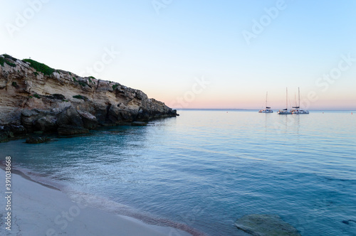 Cristal clear water and no people at the famous Cala Azzurra in Favignana, Italy. A perfect calm sunrise in this paradise island in the mediterranean sea