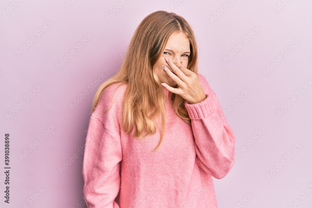 Beautiful young caucasian girl wearing casual clothes smelling something stinky and disgusting, intolerable smell, holding breath with fingers on nose. bad smell Beautiful young caucasian girl wearing casual clothes smelling something stinky and disgusting, intolerable smell, holding breath with fingers on nose. bad smell