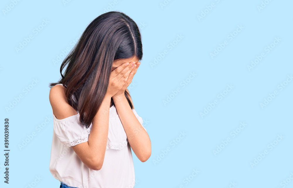 Beautiful child girl wearing casual clothes with sad expression covering face with hands while crying. depression concept. Beautiful child girl wearing casual clothes with sad expression covering face with hands while crying. depression concept.
