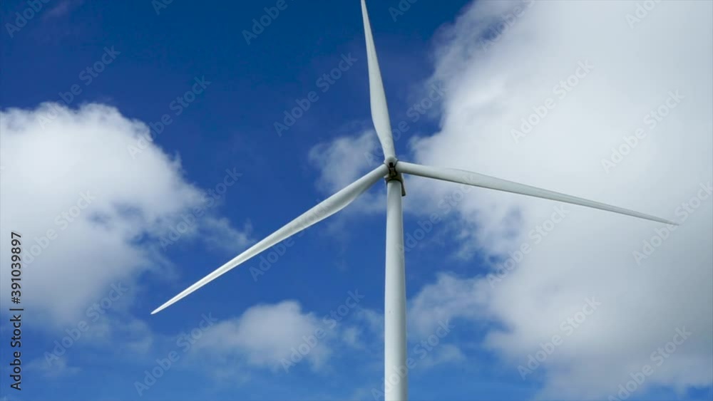Aerial view of powerful Wind turbine farm for energy production on beautiful cloudy sky at highland.Wind mill, clouds and blue sky.Wind power turbines generating renewable clean energy. Aerial view of powerful Wind turbine farm for energy production on beautiful cloudy sky at highland.Wind mill, clouds and blue sky.Wind power turbines generating renewable clean energy.