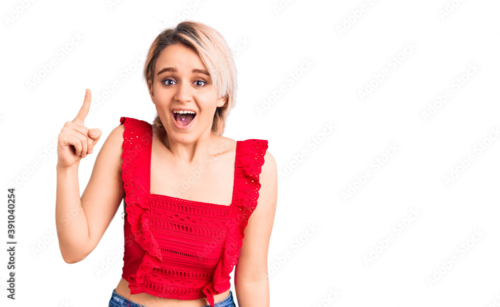 Young beautiful blonde woman wearing casual clothes pointing finger up with successful idea. exited and happy. number one. Young beautiful blonde woman wearing casual clothes pointing finger up with successful idea. exited and happy. number one.