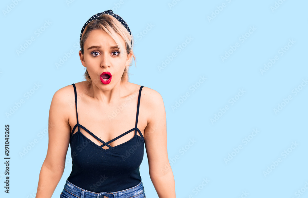 Young beautiful blonde woman wearing casual clothes scared and amazed with open mouth for surprise, disbelief face Young beautiful blonde woman wearing casual clothes scared and amazed with open mouth for surprise, disbelief face