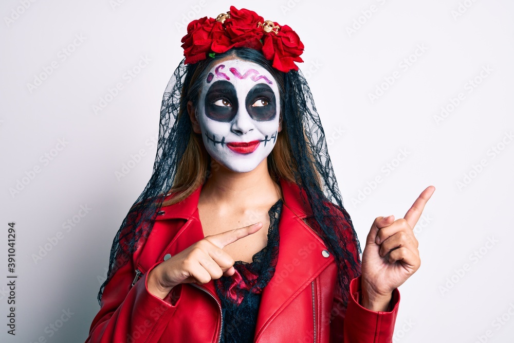 Woman wearing day of the dead costume pointing with fingers to the side smiling looking to the side and staring away thinking. Woman wearing day of the dead costume pointing with fingers to the side smiling looking to the side and staring away thinking.