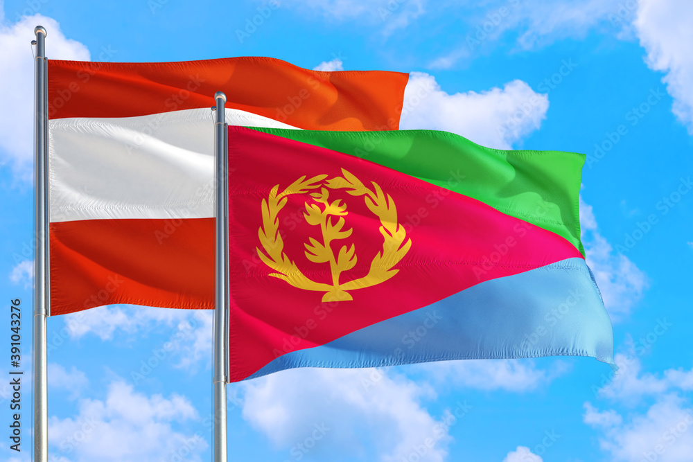Naklejka premium Eritrea and Austria national flag waving in the windy deep blue sky. Diplomacy and international relations concept.