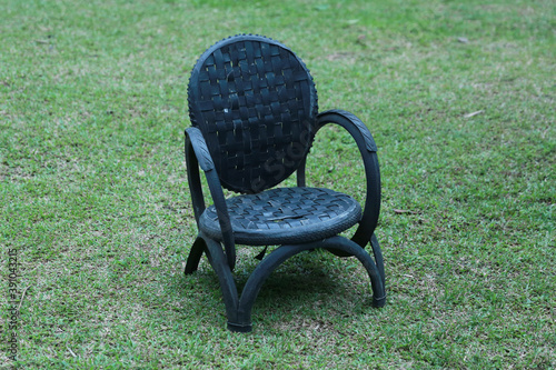 Recycle chair, black color on the grass 
