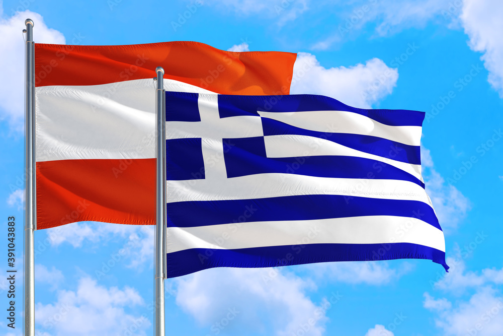 Obraz premium Greece and Austria national flag waving in the windy deep blue sky. Diplomacy and international relations concept.