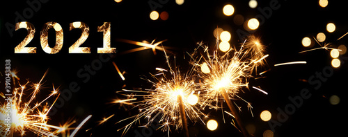 2021 in burning sparkler flames. Silvester background banner panorama sparkling lights firework. Abstract Sparklers for celebration. Magic light. Happy new year and Merry Christmas concept.