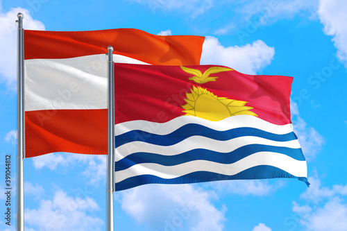 Kiribati and Austria national flag waving in the windy deep blue sky. Diplomacy and international relations concept.