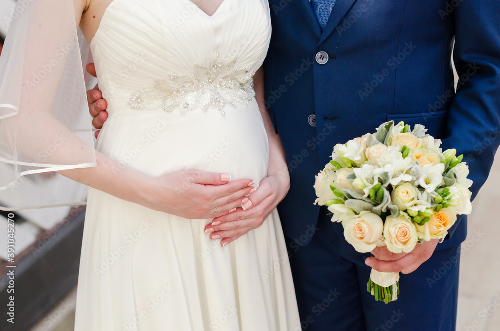 Bridegroom and pregnant bride at the wedding waiting for the baby Bridegroom and pregnant bride at the wedding waiting for the baby