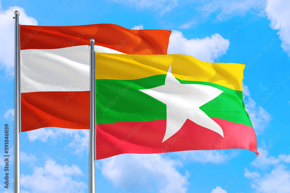 Myanmar and Austria national flag waving in the windy deep blue sky. Diplomacy and international relations concept. Myanmar and Austria national flag waving in the windy deep blue sky. Diplomacy and international relations concept.