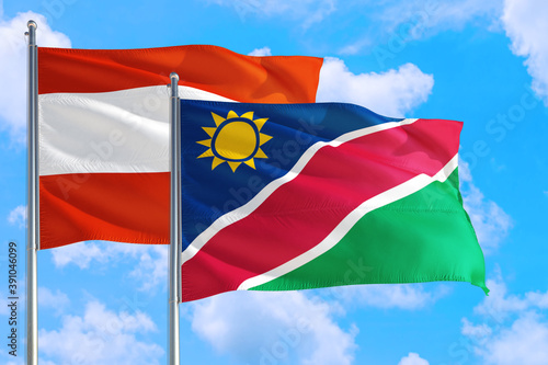 Namibia and Austria national flag waving in the windy deep blue sky. Diplomacy and international relations concept.
