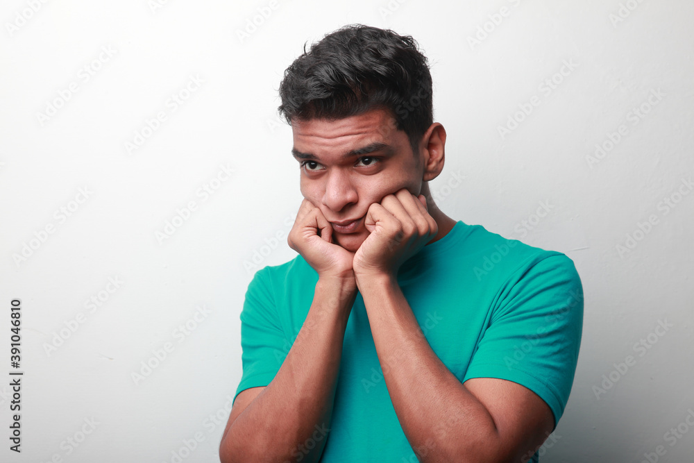 Young man of Indian origin with a worried face Young man of Indian origin with a worried face