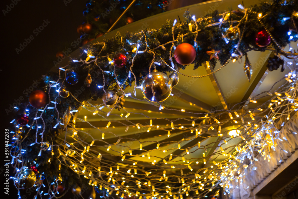 Christmas garland lights in the city. Soft focus background.