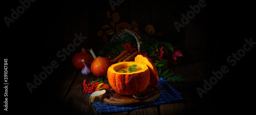 Delicious autumn pumpkin soup with baguette photo