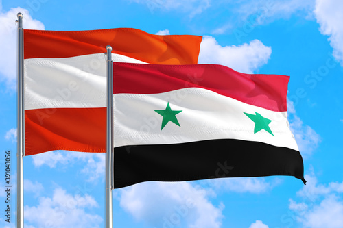 Syria and Austria national flag waving in the windy deep blue sky. Diplomacy and international relations concept.