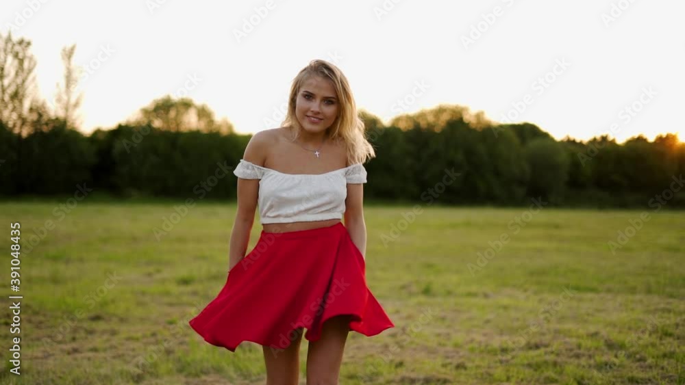 Beautiful Blond Girl Twirling in a Red Dress During a Golden Hour Sunset Beautiful Blond Girl Twirling in a Red Dress During a Golden Hour Sunset