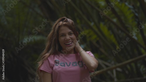 Latin girl laughs while her hair falls in her face photo