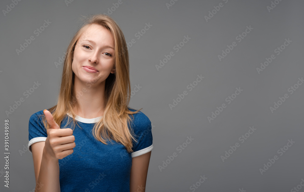 Cheerful girl looking at the camera with happy expression, showing OK sign, thumb up, excellent job. Cheerful girl looking at the camera with happy expression, showing OK sign, thumb up, excellent job.