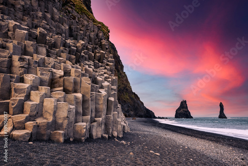 Incredible view on Black beach and Troll toes cliffs in sunset time Fototapeta