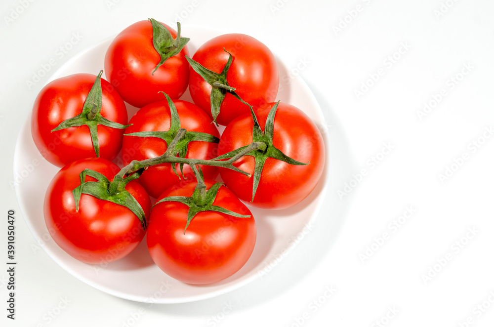 several red tomatoes on a branch isolated on white background