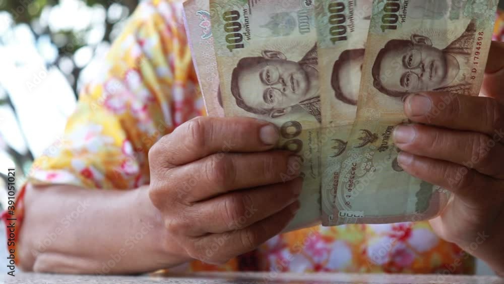 counting money banknote thai baht with elderly people, money cash in hand are counting for pay, old people thai and money for savings business concept