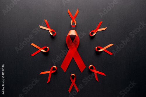 Red ribbon awareness on dark background for World Aids day campaign.