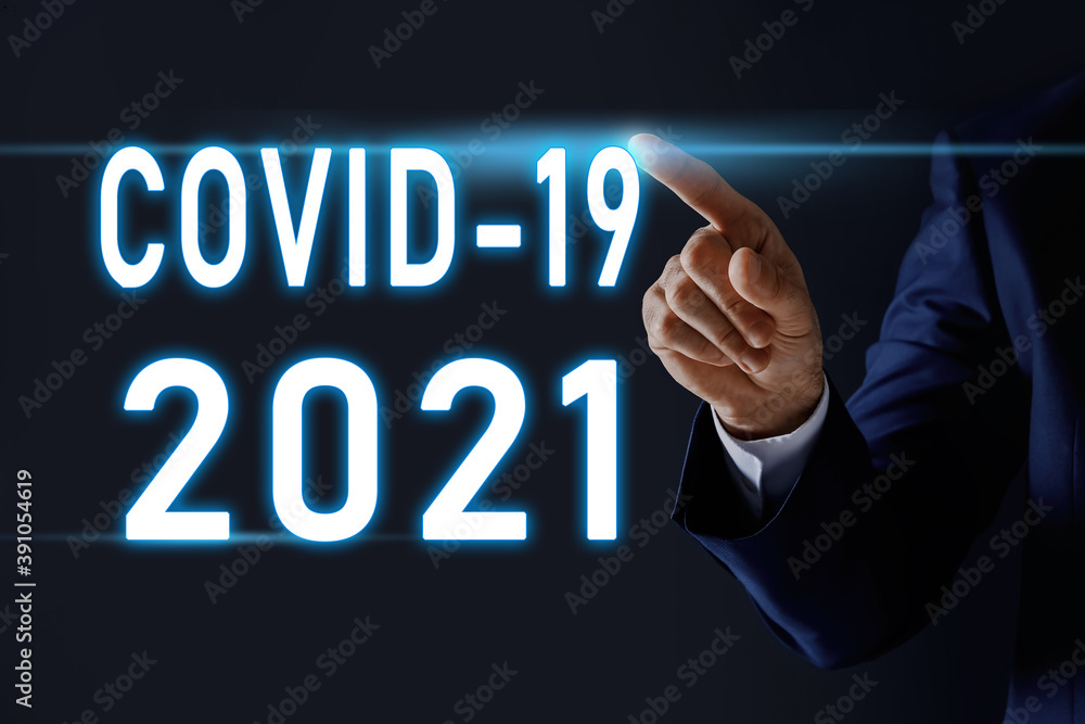 COVID-19 predictions for 2021 year. Man and text on dark background, closeup COVID-19 predictions for 2021 year. Man and text on dark background, closeup