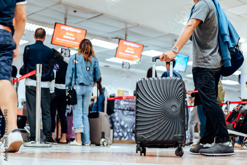 people waiting for check in at airport. A man and luggage at the airport terminal.