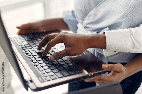 Black man. Guy in a blue shirt. Students with a laptop. Girl in blue blouse.