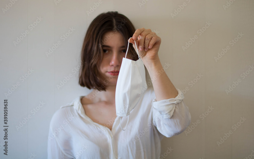 A business woman holding a face mask, holding a mask with hands, a person holding masks, business woman gets rid of the mask A business woman holding a face mask, holding a mask with hands, a person holding masks, business woman gets rid of the mask